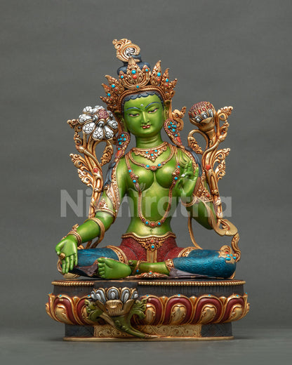 Front view of handcrafted Green Tara statue on lotus pedestal with gold crown and jewelry