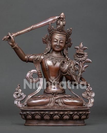 Front view of handcrafted Manjushri statue in oxidized copper from Patan, Nepal