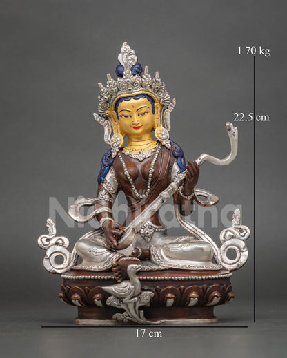 Front view of handcrafted Saraswati goddess statue from Nepal with gold-painted face and veena