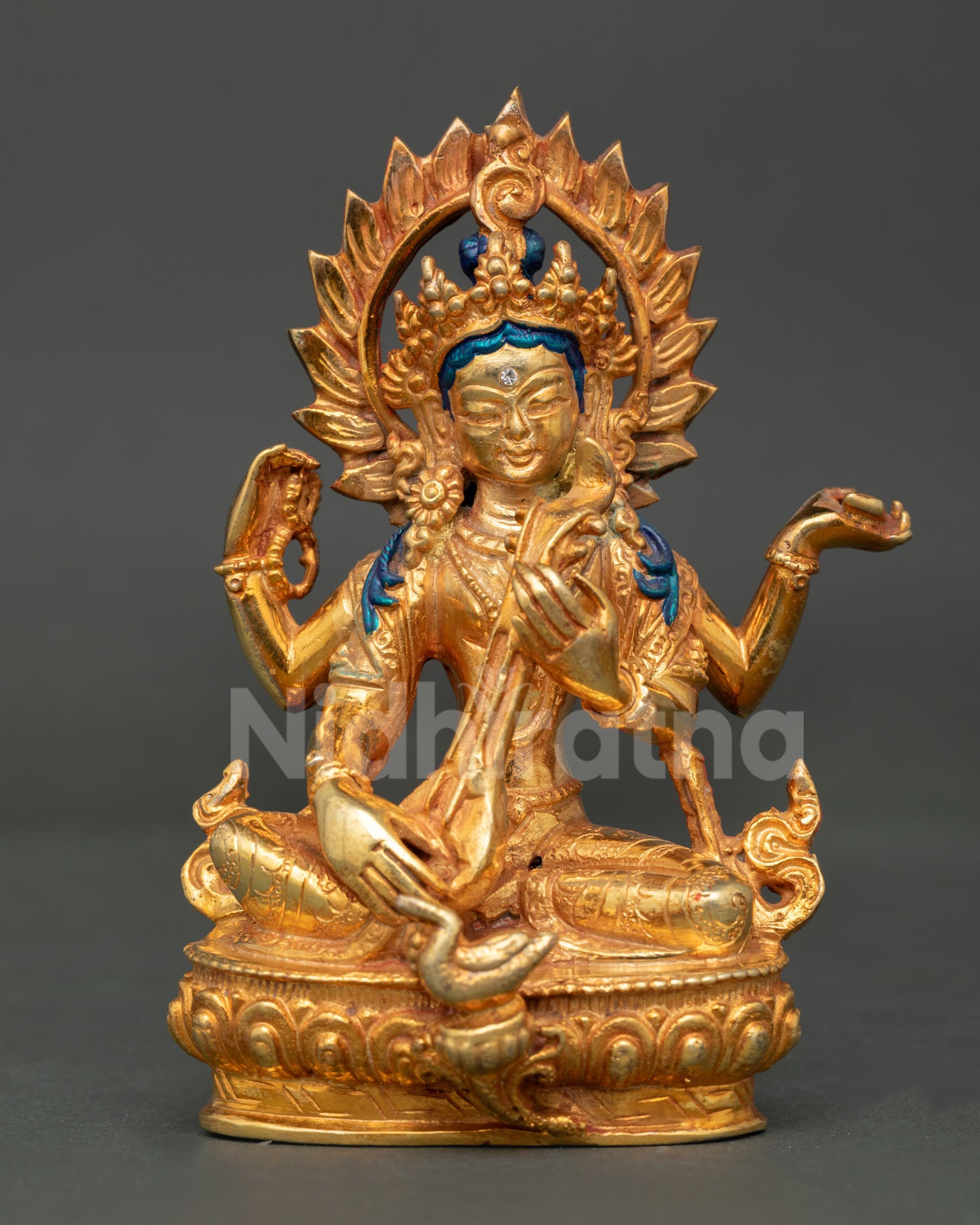 Front view of handcrafted Saraswati statue in copper with gold plated finish and veena symbol of wisdom and knowledge