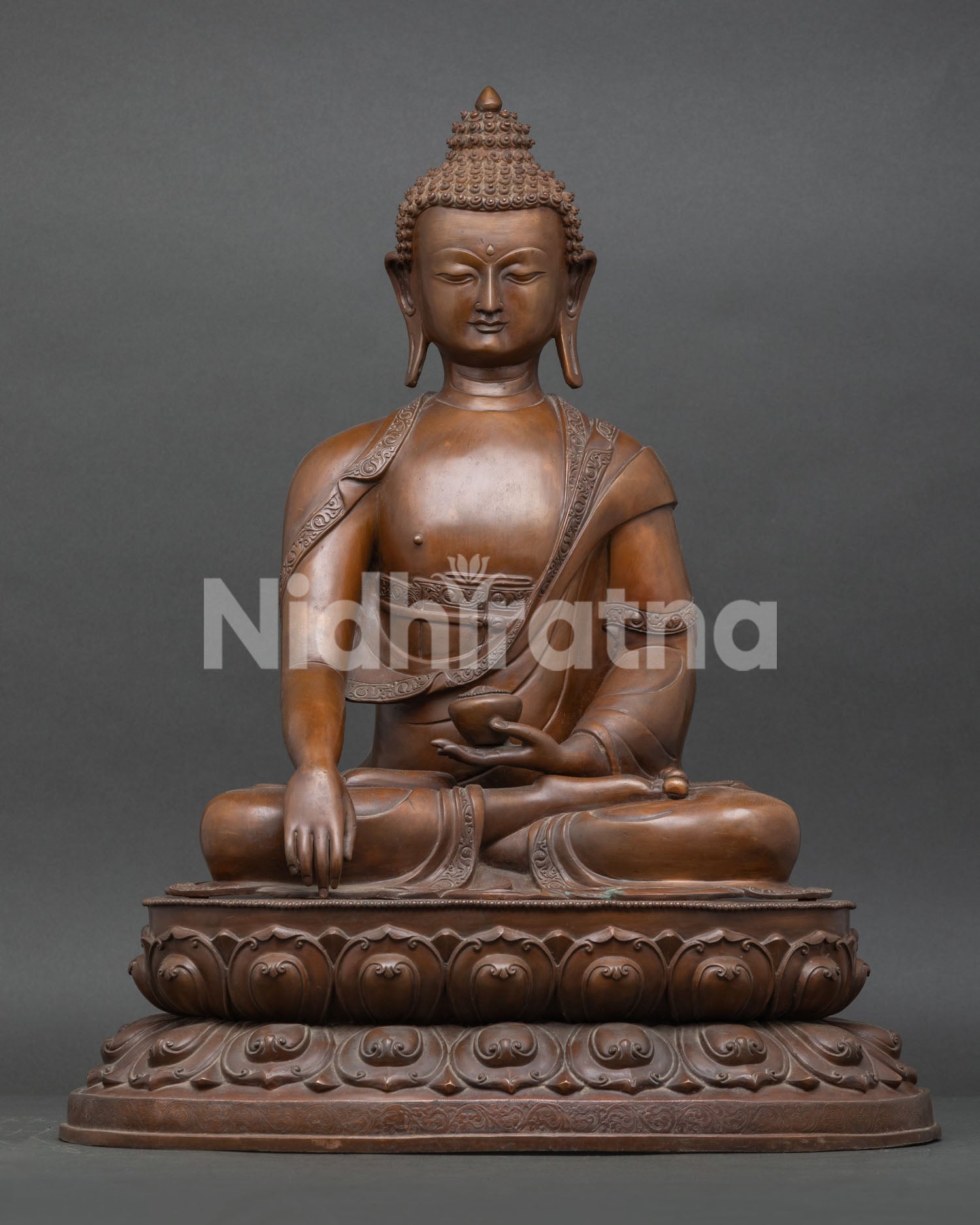 Front view of handcrafted Shakyamuni Buddha statue in Bhumisparsha mudra, oxidized copper, Nepal