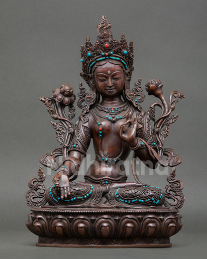 Front view of handcrafted White Tara Saptalocana statue from Nepal in oxidized copper with turquoise and coral stones seated on lotus pedestal