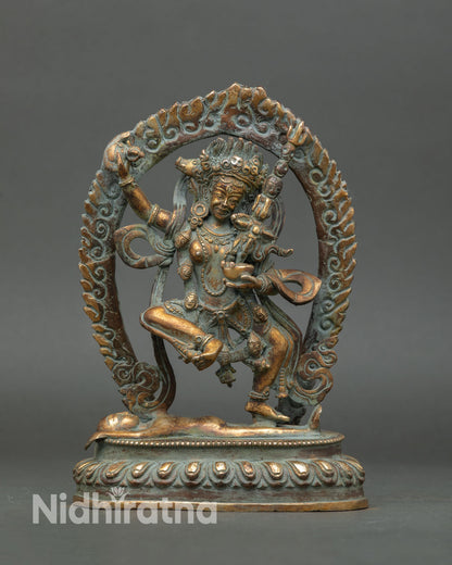 Front view of handmade Dorje Phagmo statue Tibetan dakini sculpture in copper gold gilded antique finish standing on subdued figure