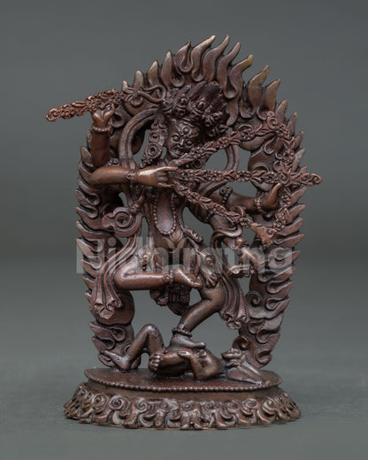 Front view of handmade Kurukulla statue in oxidized copper standing on lotus pedestal with flaming aureole