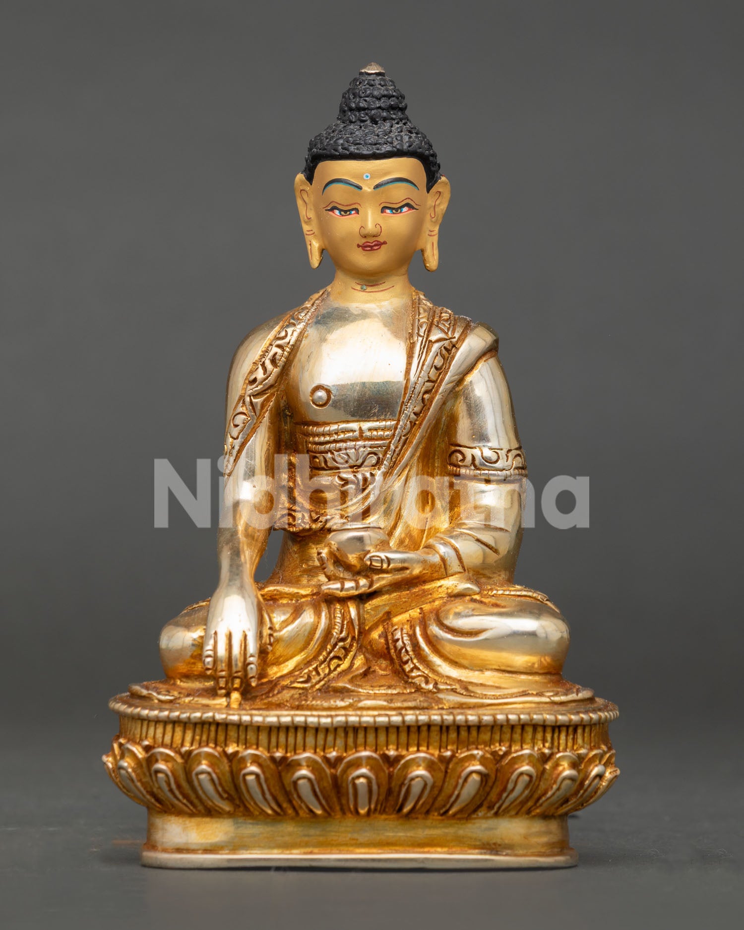 Front view of Handmade Shakyamuni Buddha Statue with gold gilding and lotus pedestal from Nepal