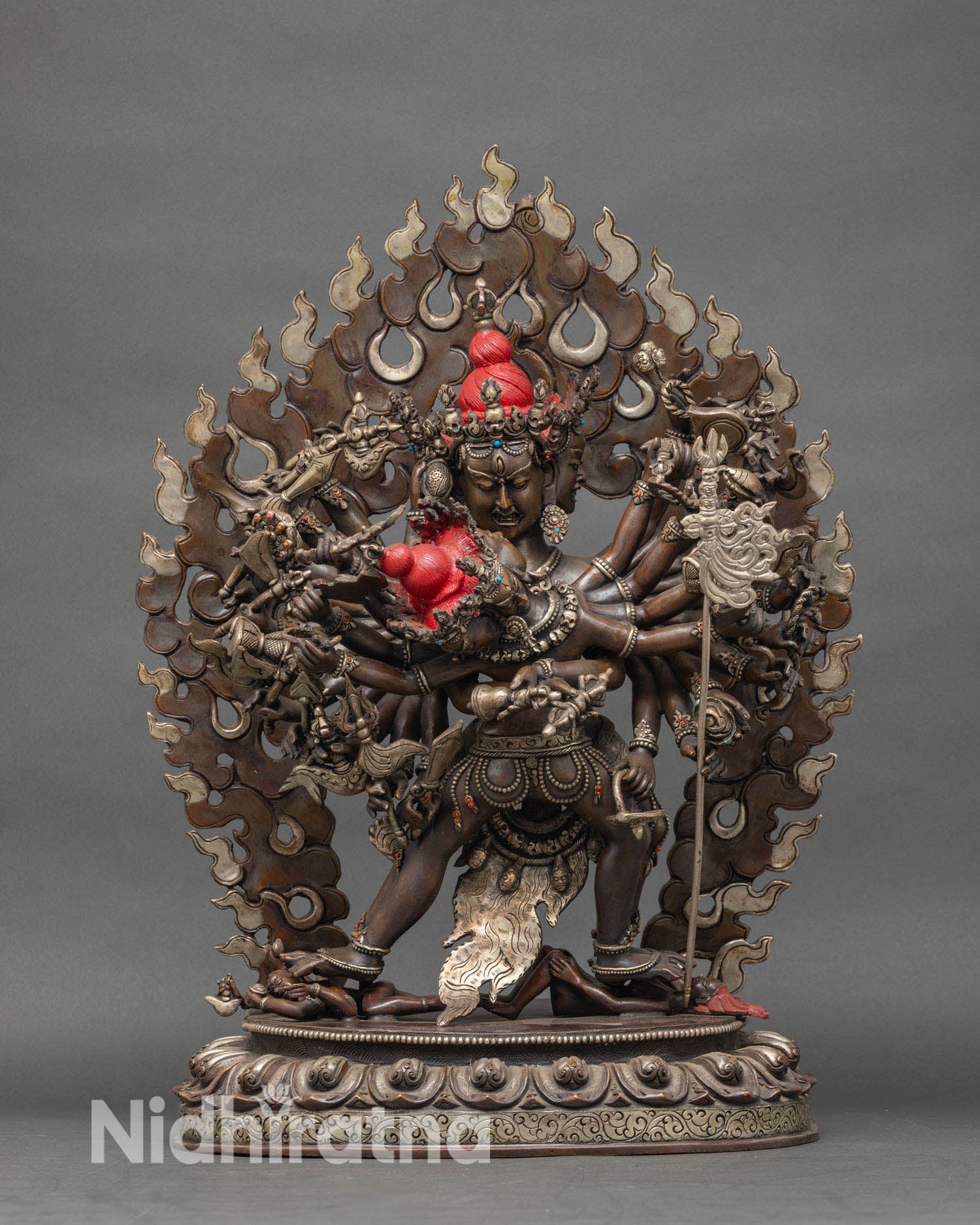 Front view of Kalachakra oxidized copper statue with four faces and twenty four arms from Nepal