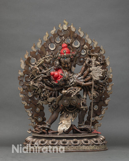 Front view of Kalachakra oxidized copper statue with four faces and twenty four arms from Nepal