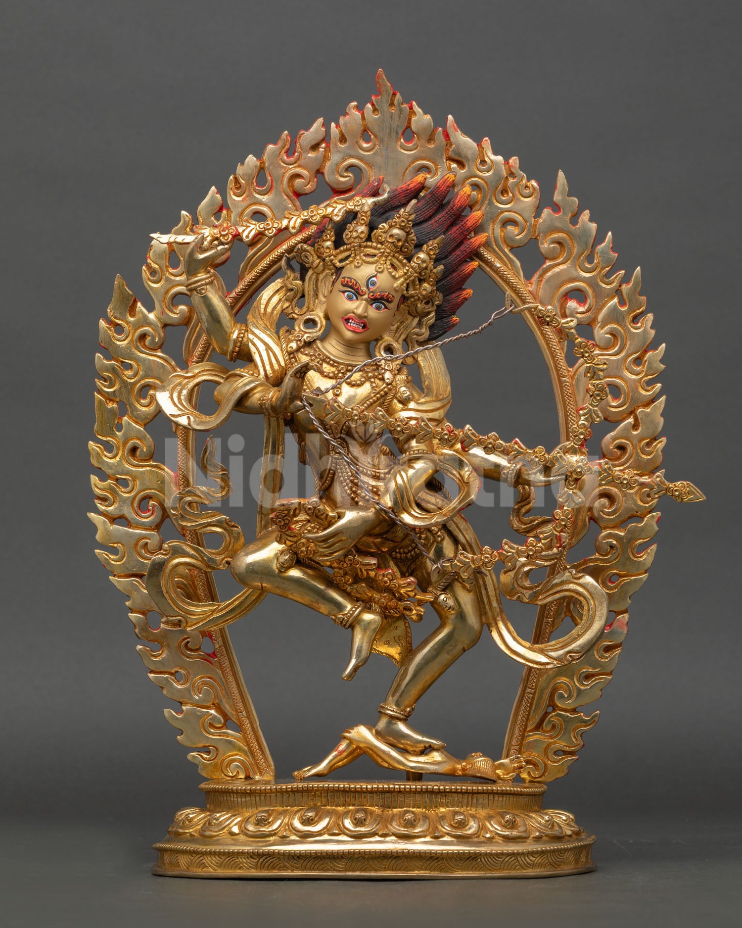 Front view of Kurukulla statue handmade in copper with 24K gold fire gilding standing on lotus throne with blazing halo and gold painted face
