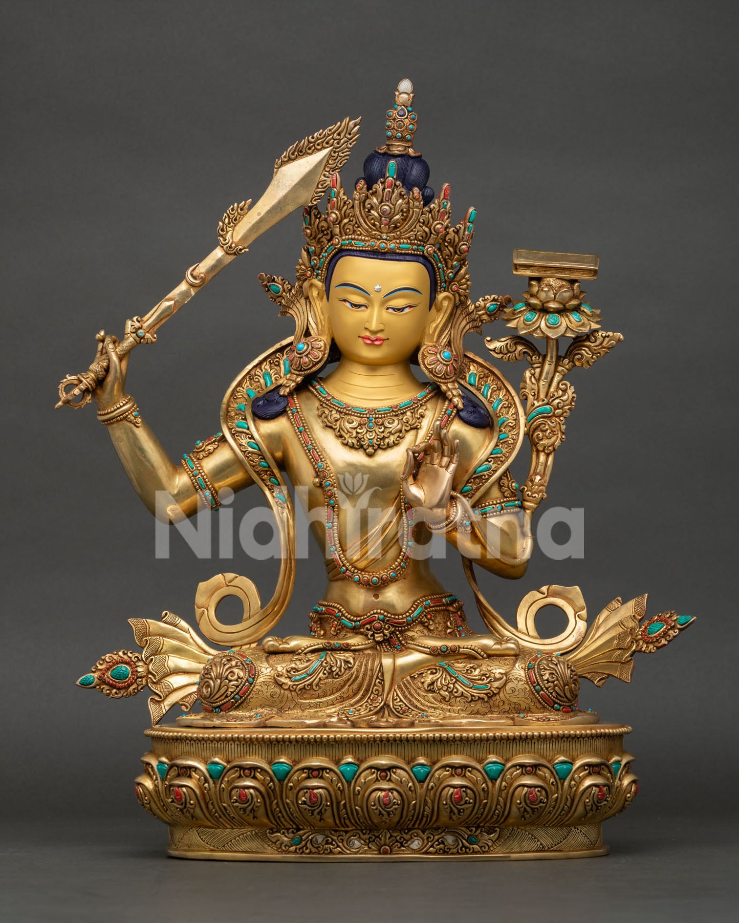 Front view of Manjushri Bodhisattva statue holding wisdom sword and lotus scripture from Nepal