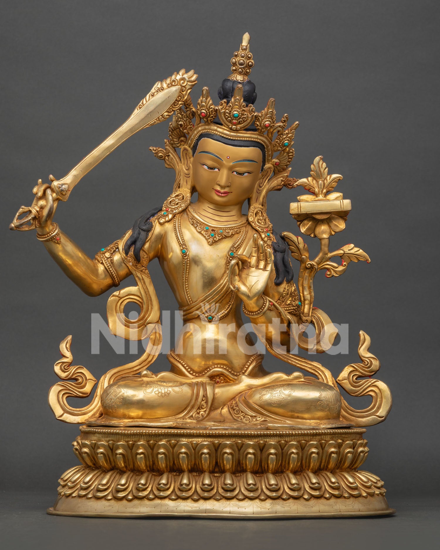Front view of Manjushri statue handcrafted in copper with 24K gold fire gilding and gold painted face from Nepal