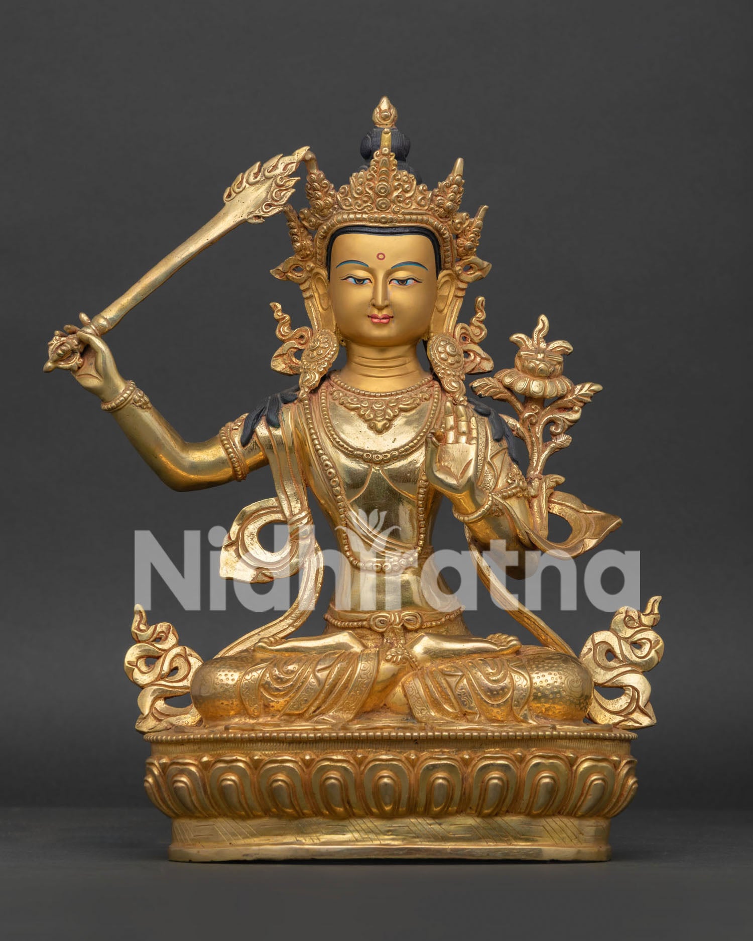 Front view of Manjushri Statue with gold gilded body and detailed lotus throne.