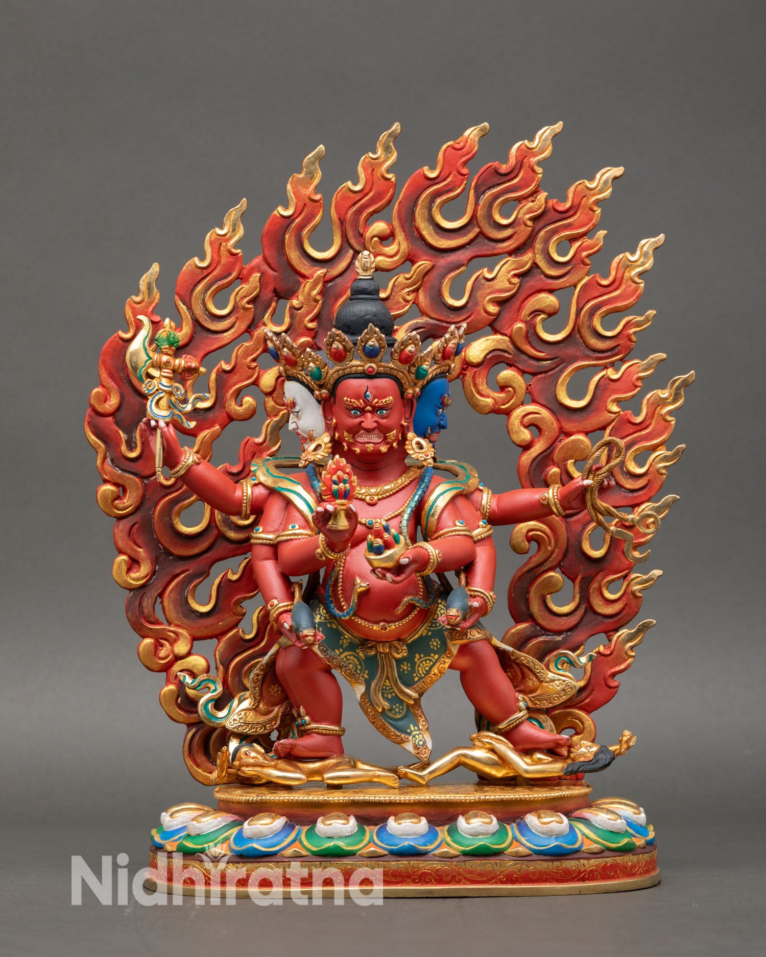 Front view of Marpo Red Dzambhala statue three fierce faces six arms copper gold gilded semi precious