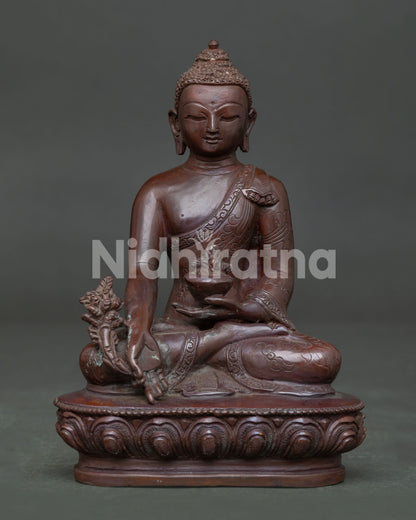 Front view of Medicine Buddha Statue handcrafted from oxidized copper on a lotus pedestal.