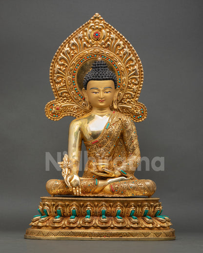 front view of medicine buddha statue with gold gilding and lotus throne