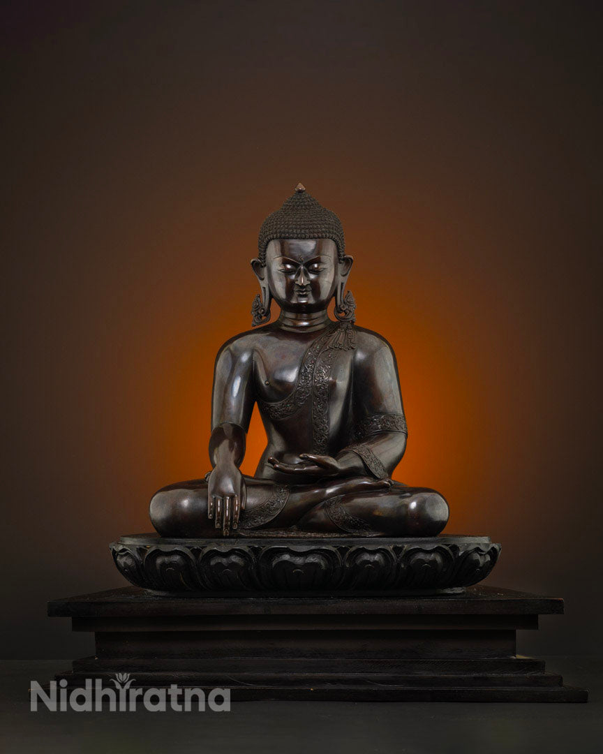 Front view of meditating Shakyamuni Buddha statue in bhumisparsa mudra on wooden base, made in Nepal