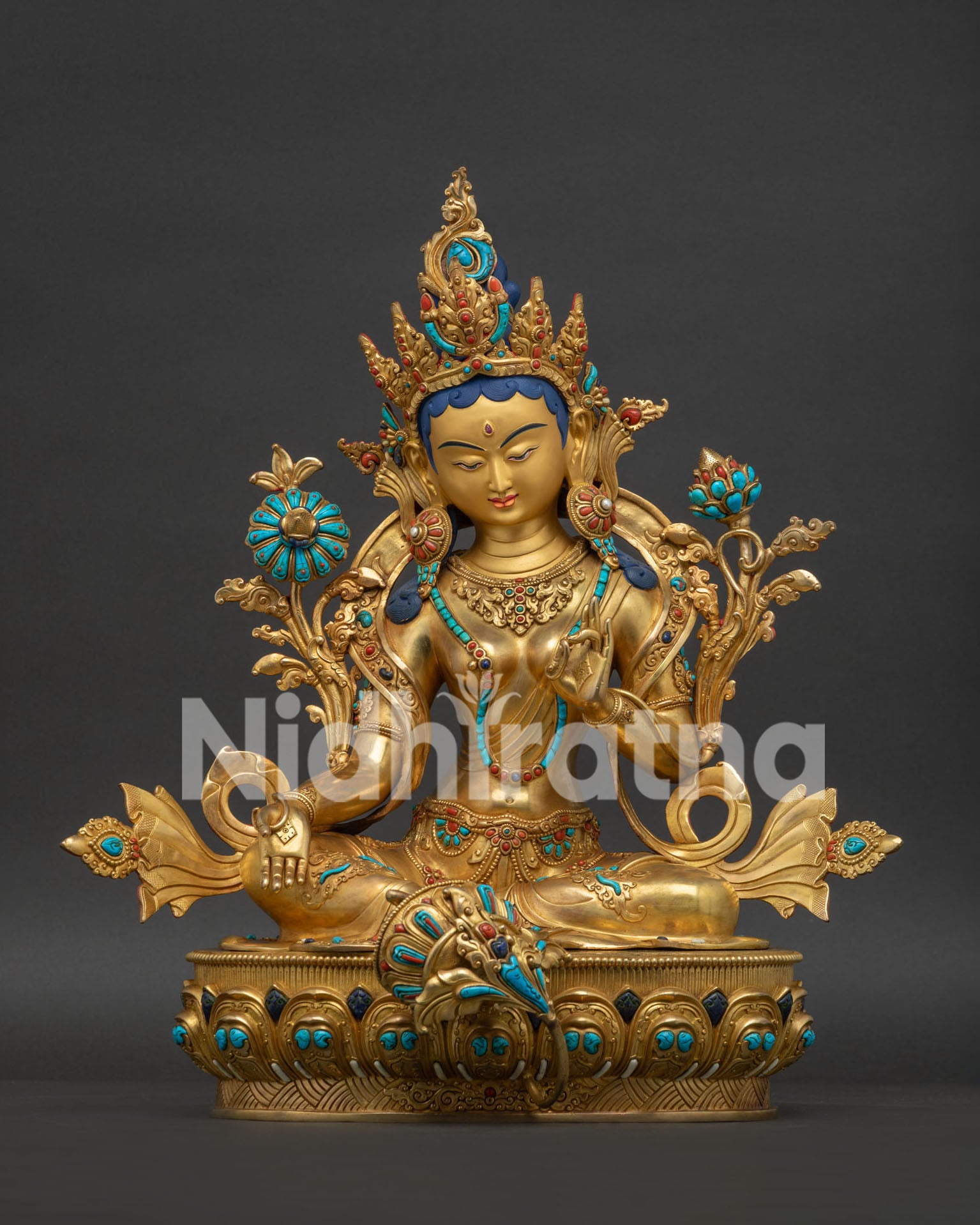 Front view of Nepali gold-gilded copper Green Tara statue with turquoise stones and lotus.
