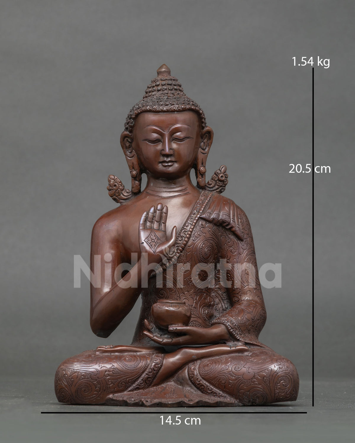 Front view of oxidized copper Amoghasiddhi Buddha statue in abhaya mudra with sacred bowl