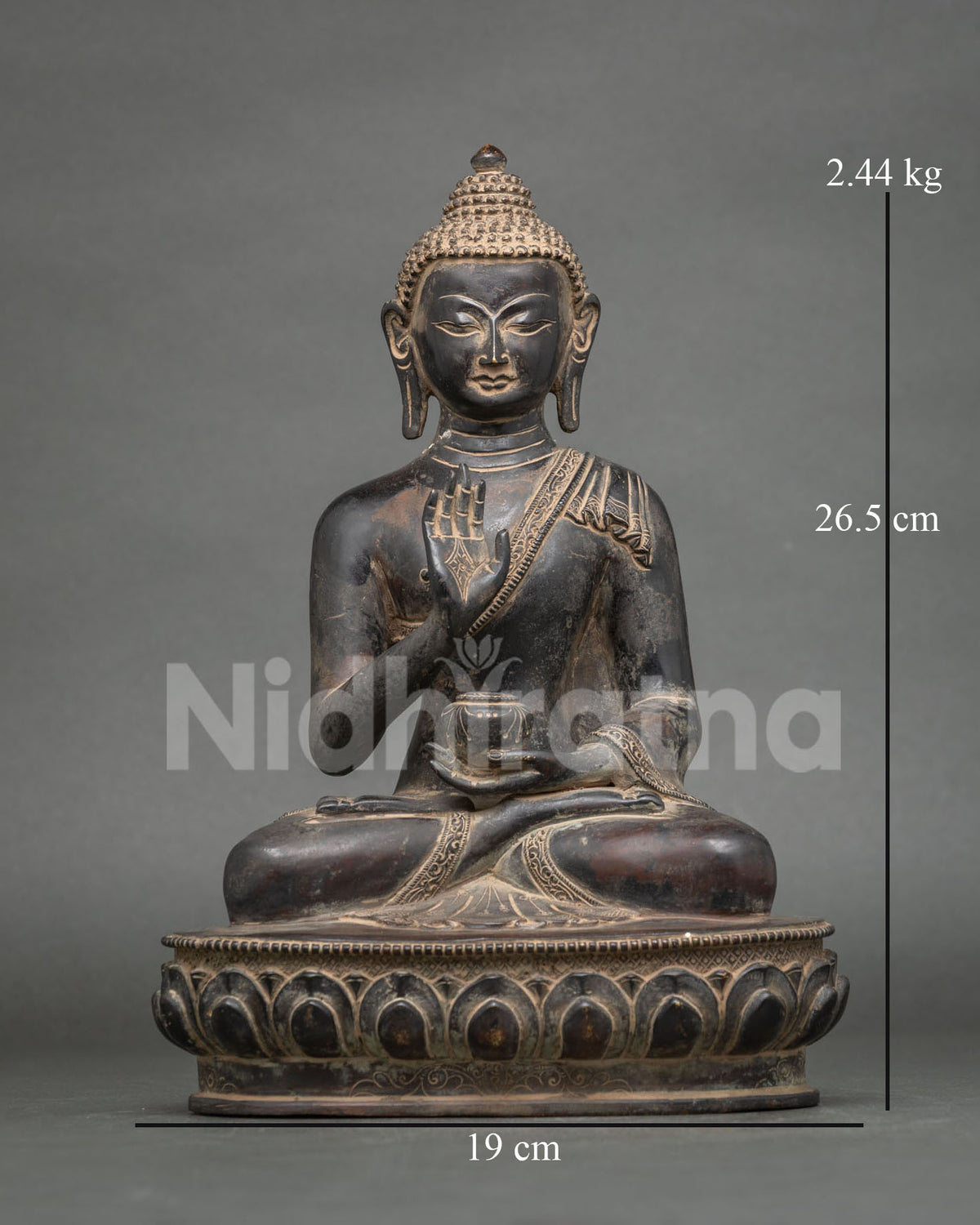Front view of oxidized copper Amoghasiddhi Buddha statue on lotus pedestal with bowl and abhaya mudra