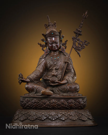 Front view of oxidized copper Guru Rinpoche statue seated on double lotus base, handmade in Nepal