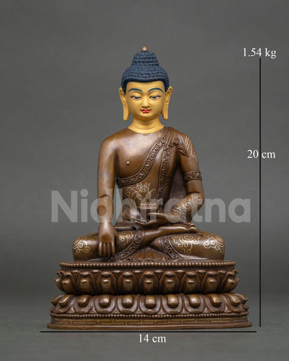 Front view of oxidized copper Shakyamuni Buddha statue with gold-painted face, handcrafted in Nepal