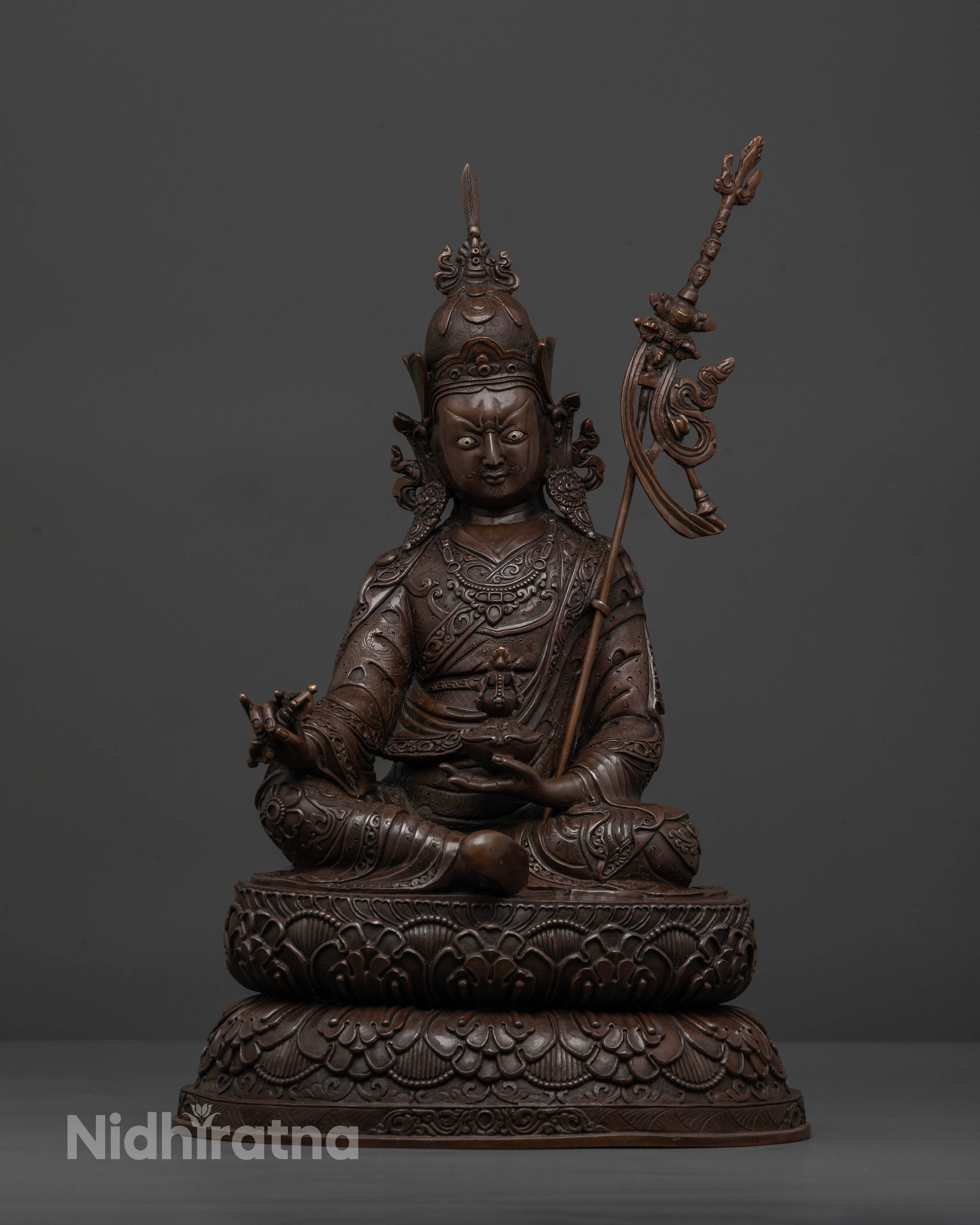 Front view of oxidized Guru Rinpoche statue with detailed 3D carved copper artwork