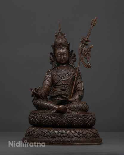 Front view of oxidized Guru Rinpoche statue with detailed 3D carved copper artwork