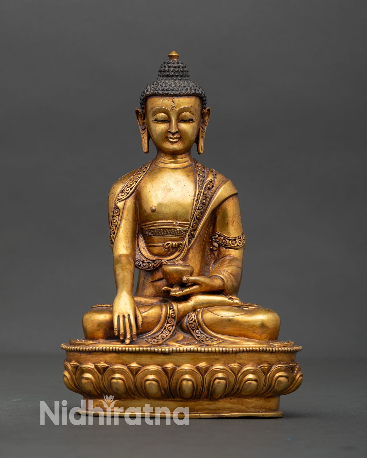 Front view of Shakyamuni Buddha statue antique style copper sculpture with gold gilding and gold painted face handcrafted Newari Buddhist art