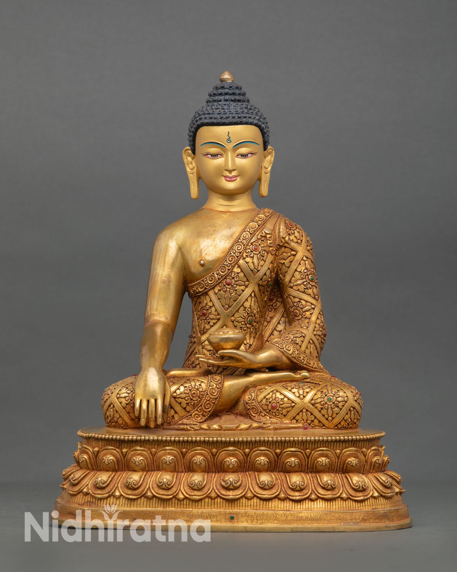 Front view of Shakyamuni Buddha statue handcrafted in Nepal with copper alloy body gold fire gilding, hand painted face and double lotus pedestal 