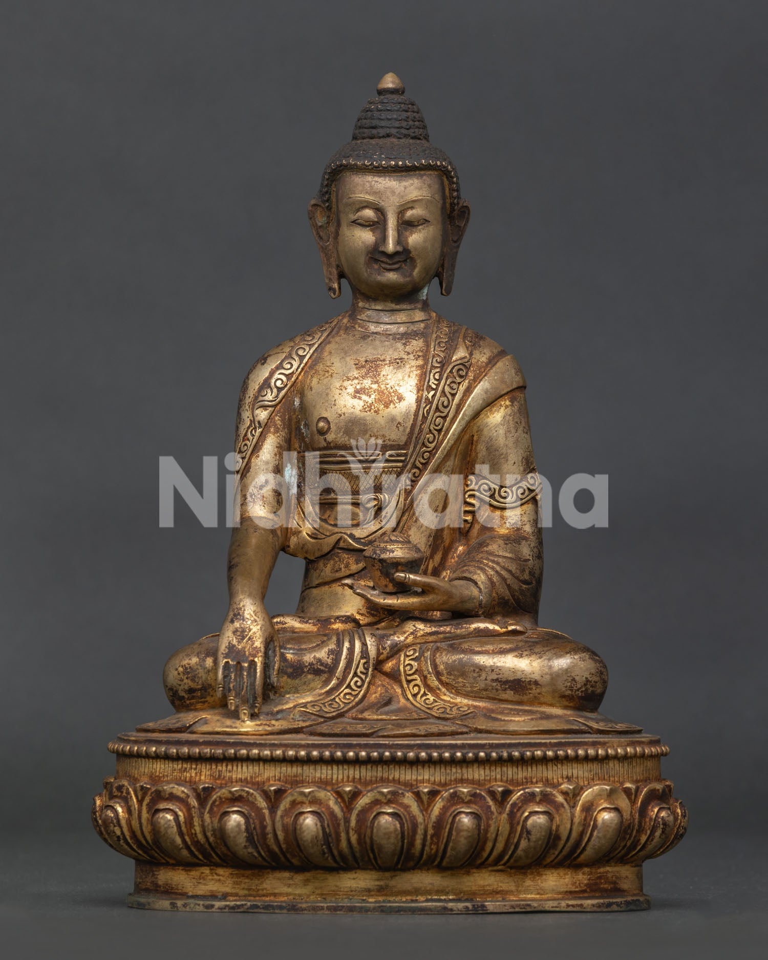 Front view of Shakyamuni Buddha Statue with antique gold fire-gilded finish on lotus pedestal.