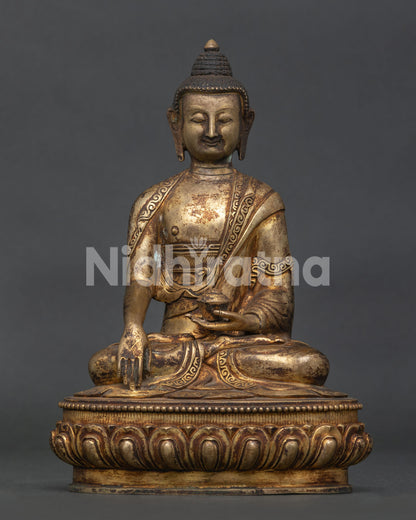 Front view of Shakyamuni Buddha Statue with antique gold fire-gilded finish on lotus pedestal.