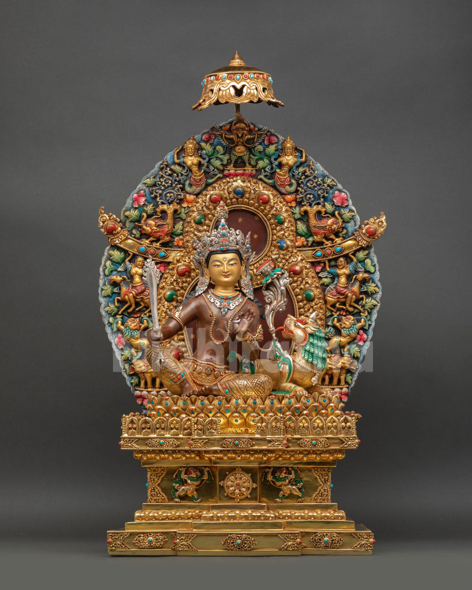 front view of simhanada manjushri statue with oxidized copper torana throne