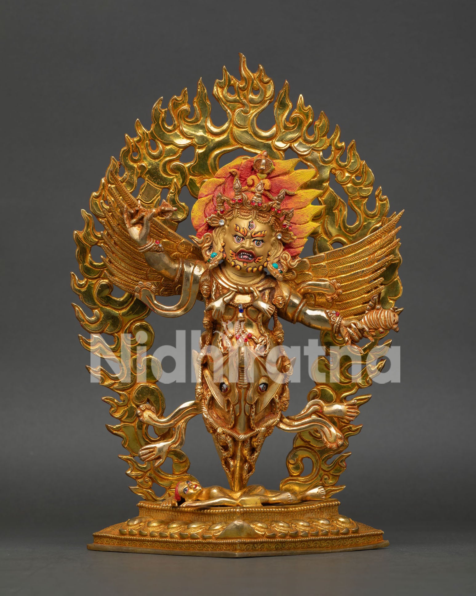 Front view of Vajrakilaya deity holding vajra and ritual knife with sacred phurba and blazing halo