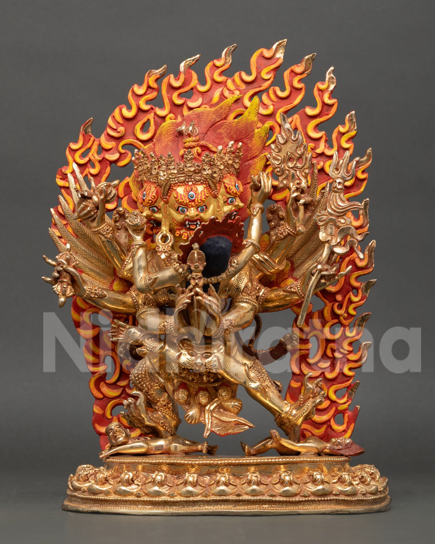 Front view of Vajrakilaya statue handmade in copper with gold gilding and wrathful gold painted face with three faces and six arms