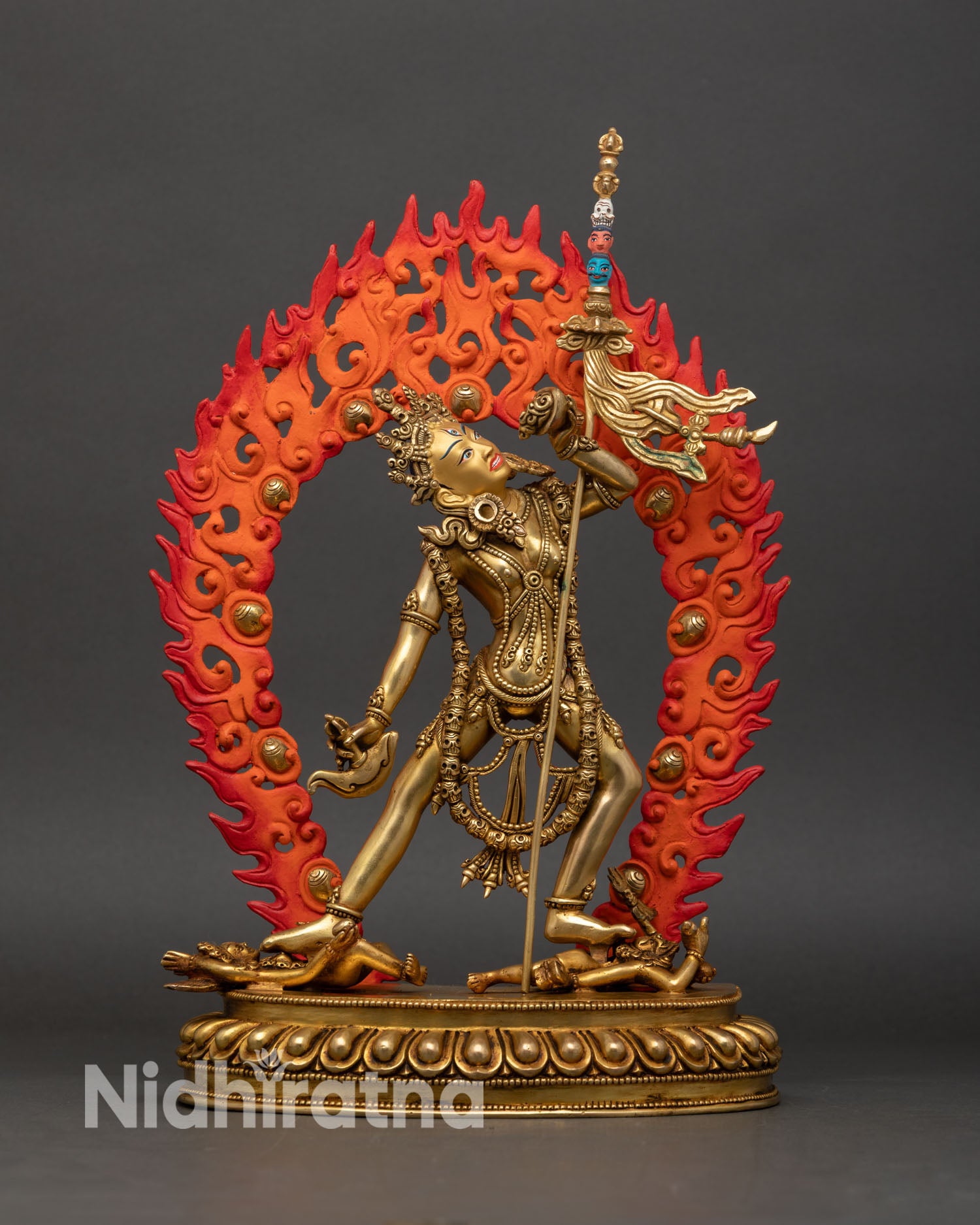 Front view of Vajrayogini statue Nepal handmade lost wax copper gold painted face wrathful expression third eye lotus pedestal tantric Buddhist art.