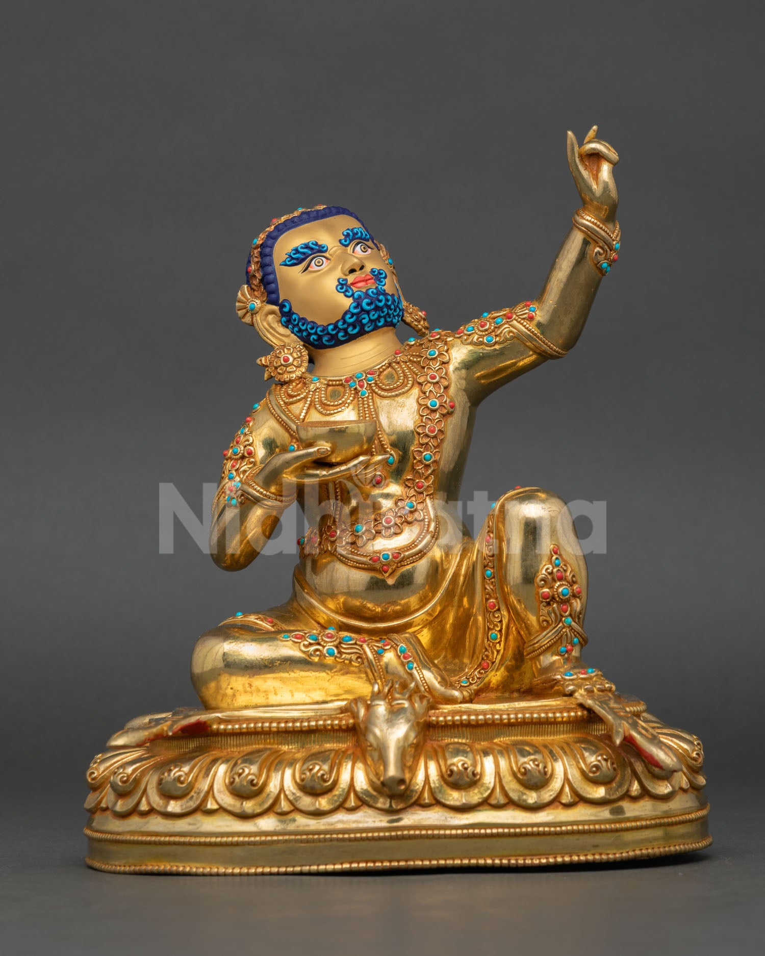 Front view of Virupa Mahasiddha statue seated on lotus throne with gold gilded copper finish from Nepal