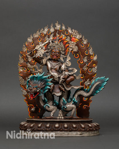 Front view of White Dzambhala statue in oxidized copper with silver-plated finish, Buddhist wealth deity