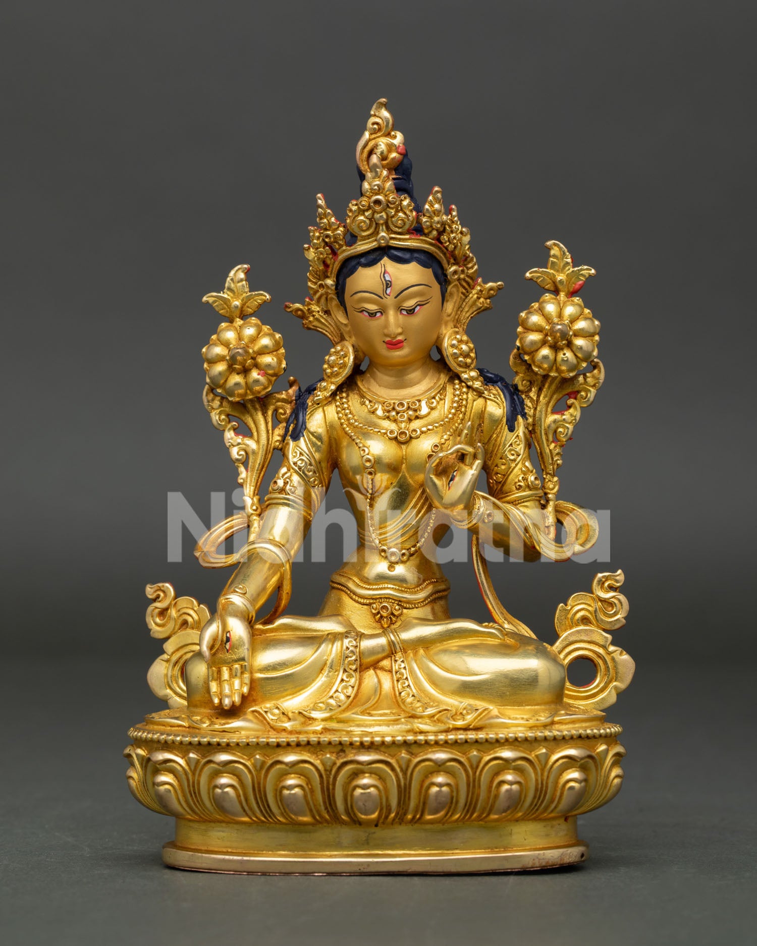 Front view of White Tara statue, handcrafted in Nepal with gold gilding and serene gold painted face