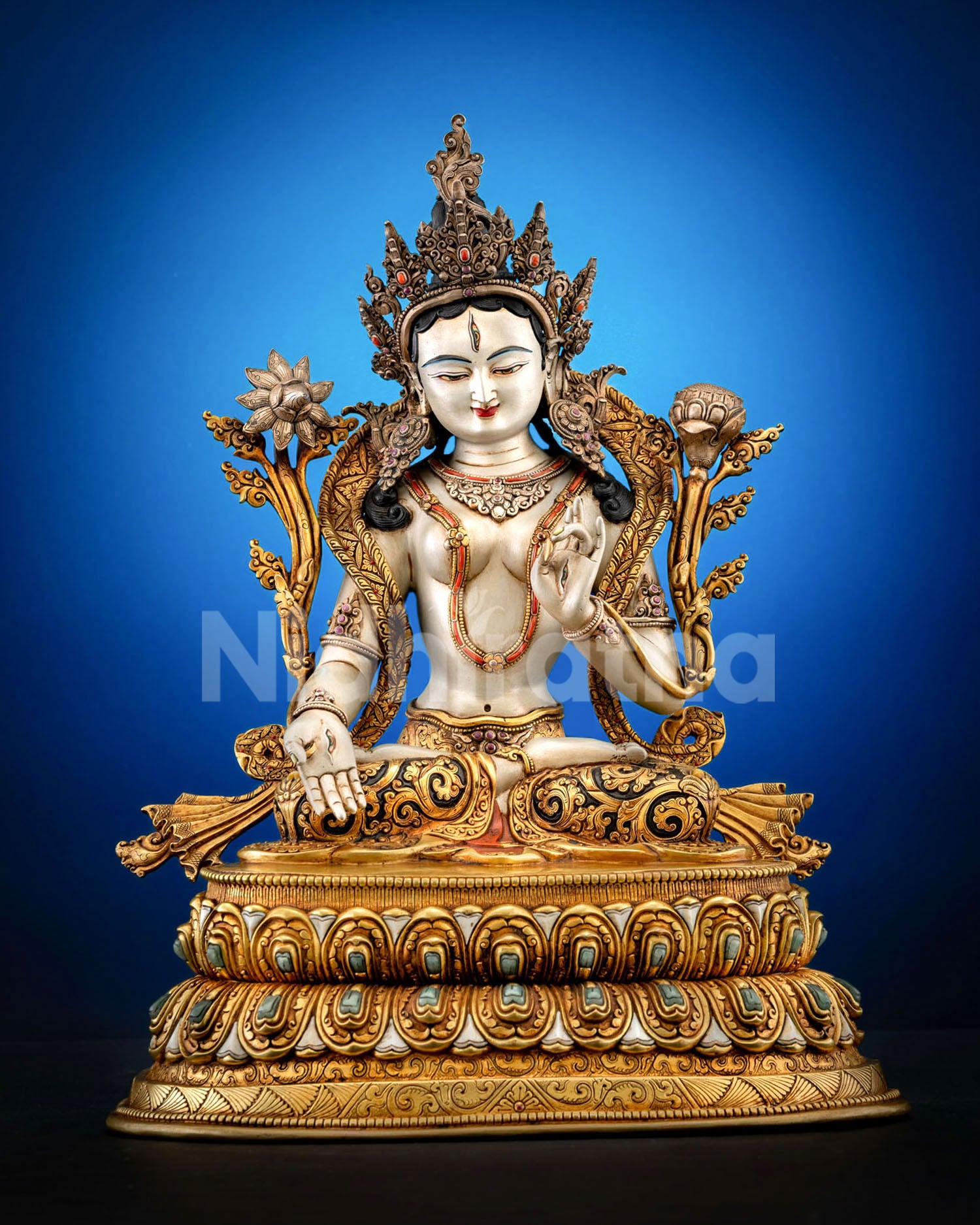 Front view of White Tara statue seated on a double lotus pedestal with a gold-gilded copper finish from Nepal