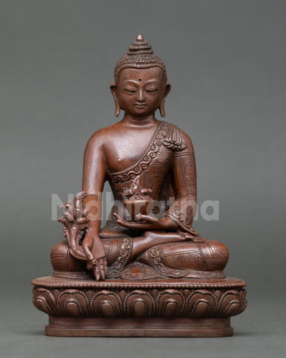Front view of Sangye Menla statue handcrafted Nepal copper oxidized finish lost wax casting healing Buddha seated lotus throne