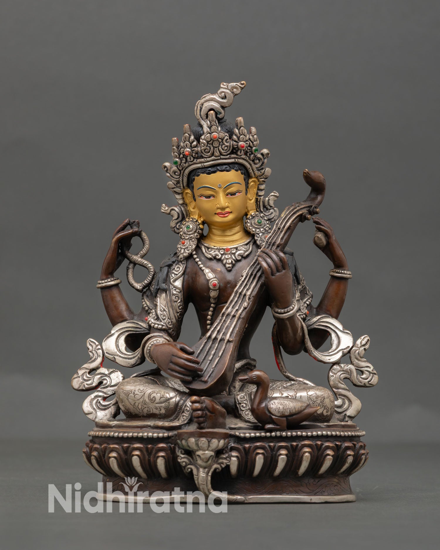 Front view of Saraswati statue Nepal copper oxidized silver detail gold face Goddess of wisdom for study meditation altar decor