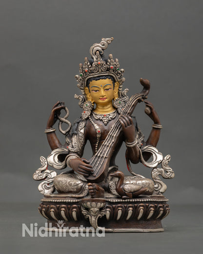 Front view of Saraswati statue Nepal copper oxidized silver detail gold face Goddess of wisdom for study meditation altar decor