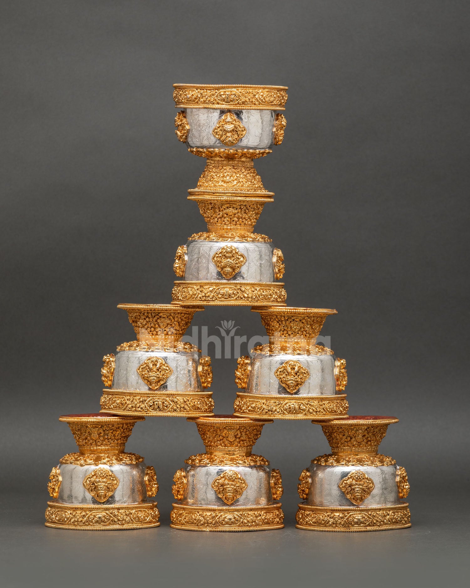 Front view set of seven water offering bowls handcrafted in copper with gold and silver plated finish featuring engraved auspicious Buddhist symbols for daily altar ritual use