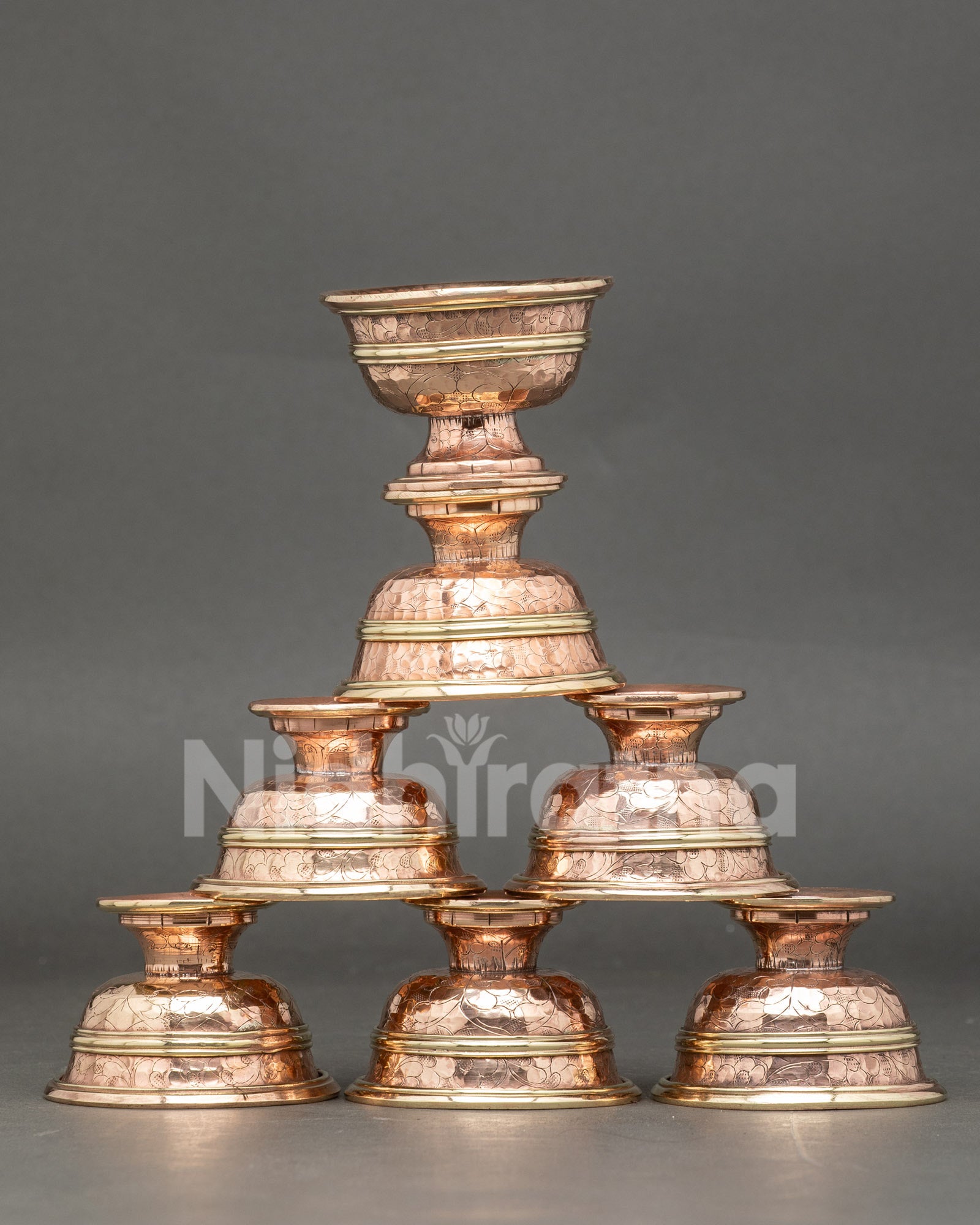 Front view seven water offering bowl set handmade copper Tibetan altar ritual bowls Nepal