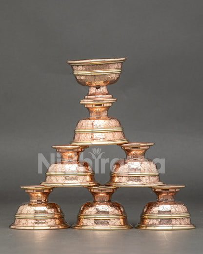Front view seven water offering bowl set handmade copper Tibetan altar ritual bowls Nepal
