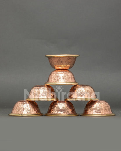 Front view seven water offering bowls handcrafted copper engraved with Buddhist symbolsc