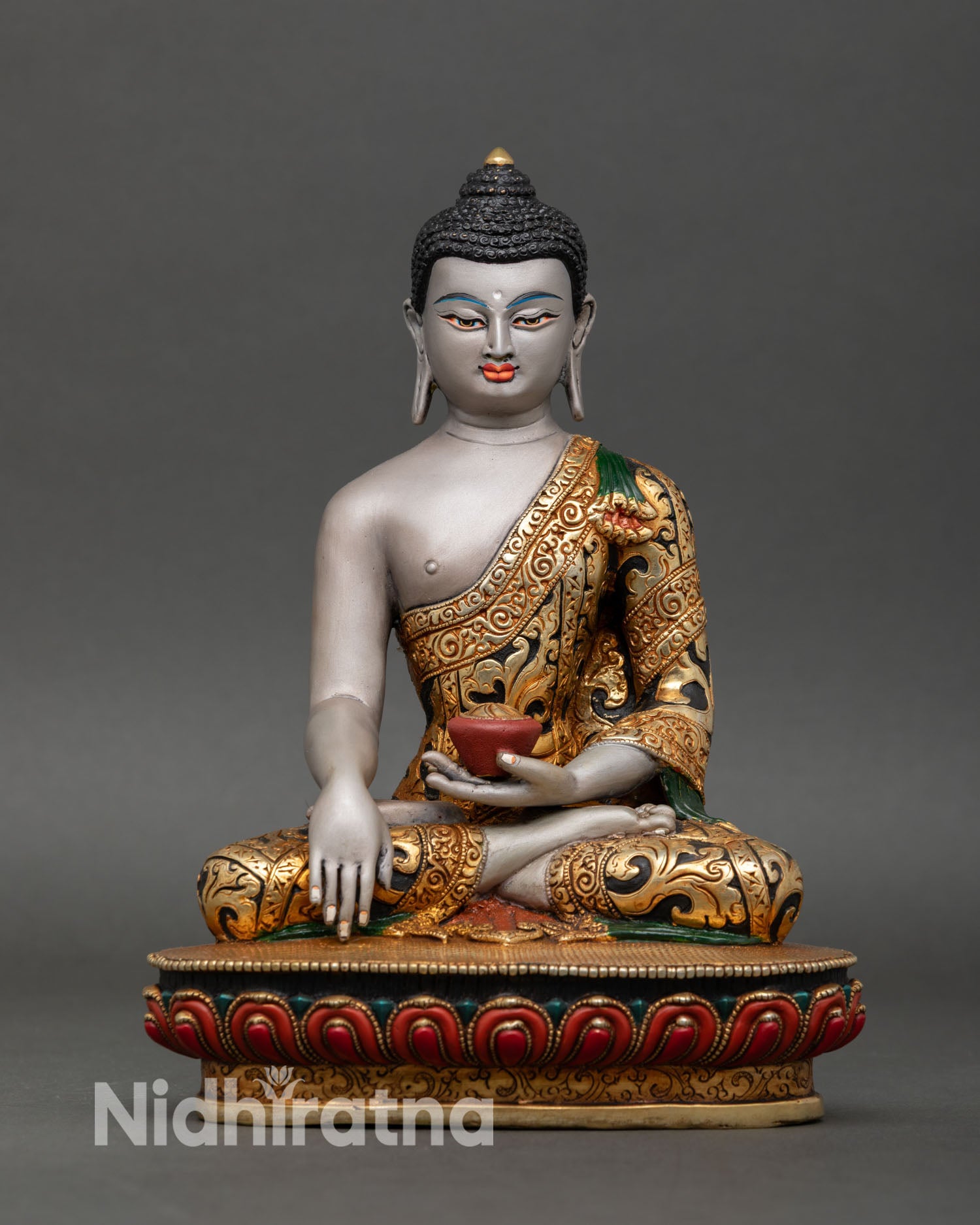 Front view of Shakyamuni Buddha figurine handcrafted in Patan Nepal lotus pedestal gold gilded monastic robe meditation statue
