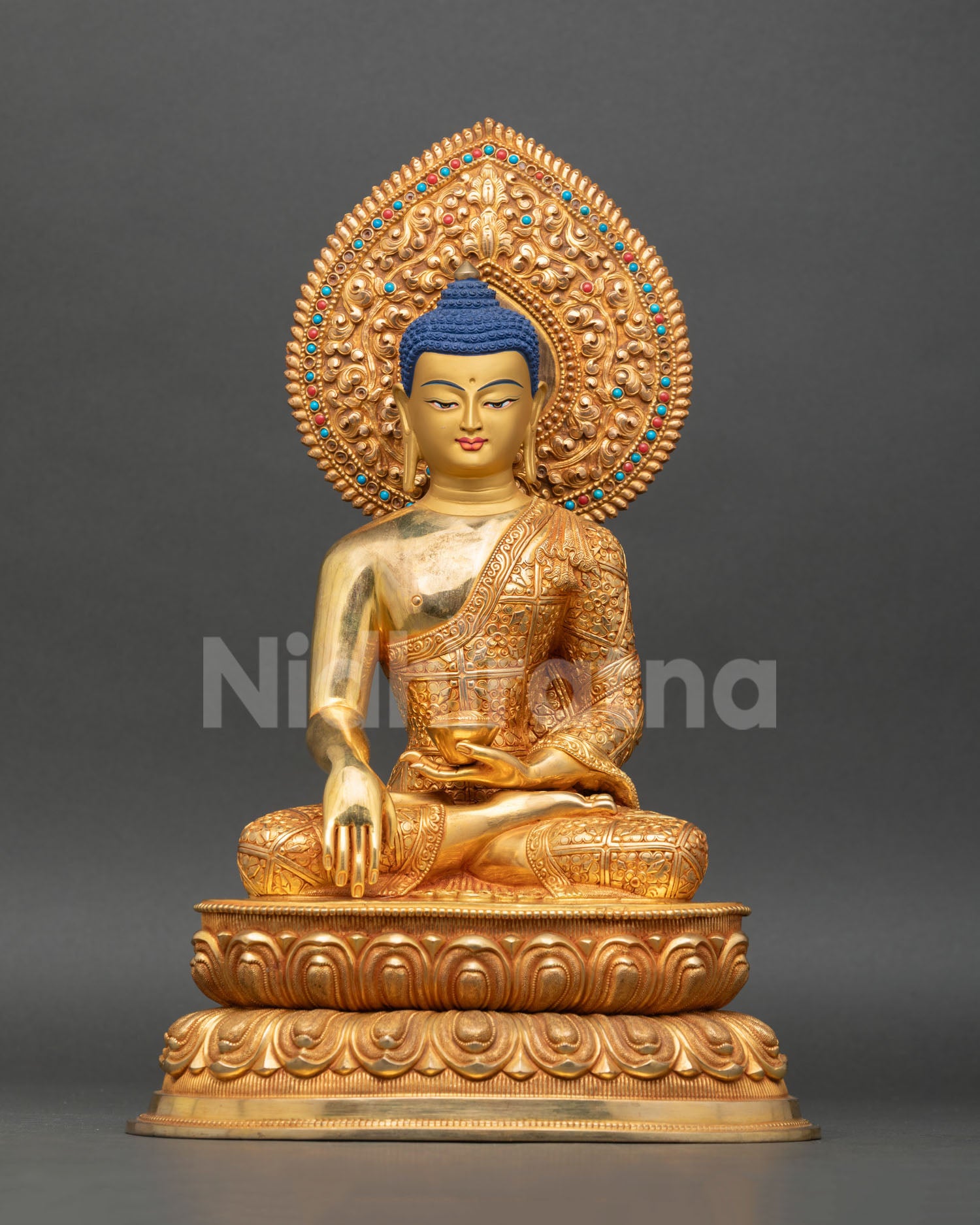 Front view of Shakyamuni Buddha copper sculpture 24K gold fire gilded face, Kathmandu Nepal Buddhist meditation altar sacred art