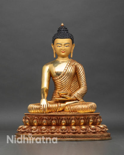 Front view of Shakyamuni Buddha statue, gold fire-gilded copper, seated on lotus throne