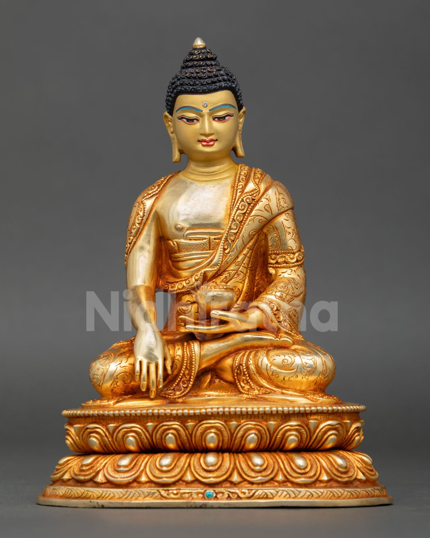 Front view of Shakyamuni Buddha statue handmade in Nepal by Newari artist copper sculpture with gold gilded accents gold painted face