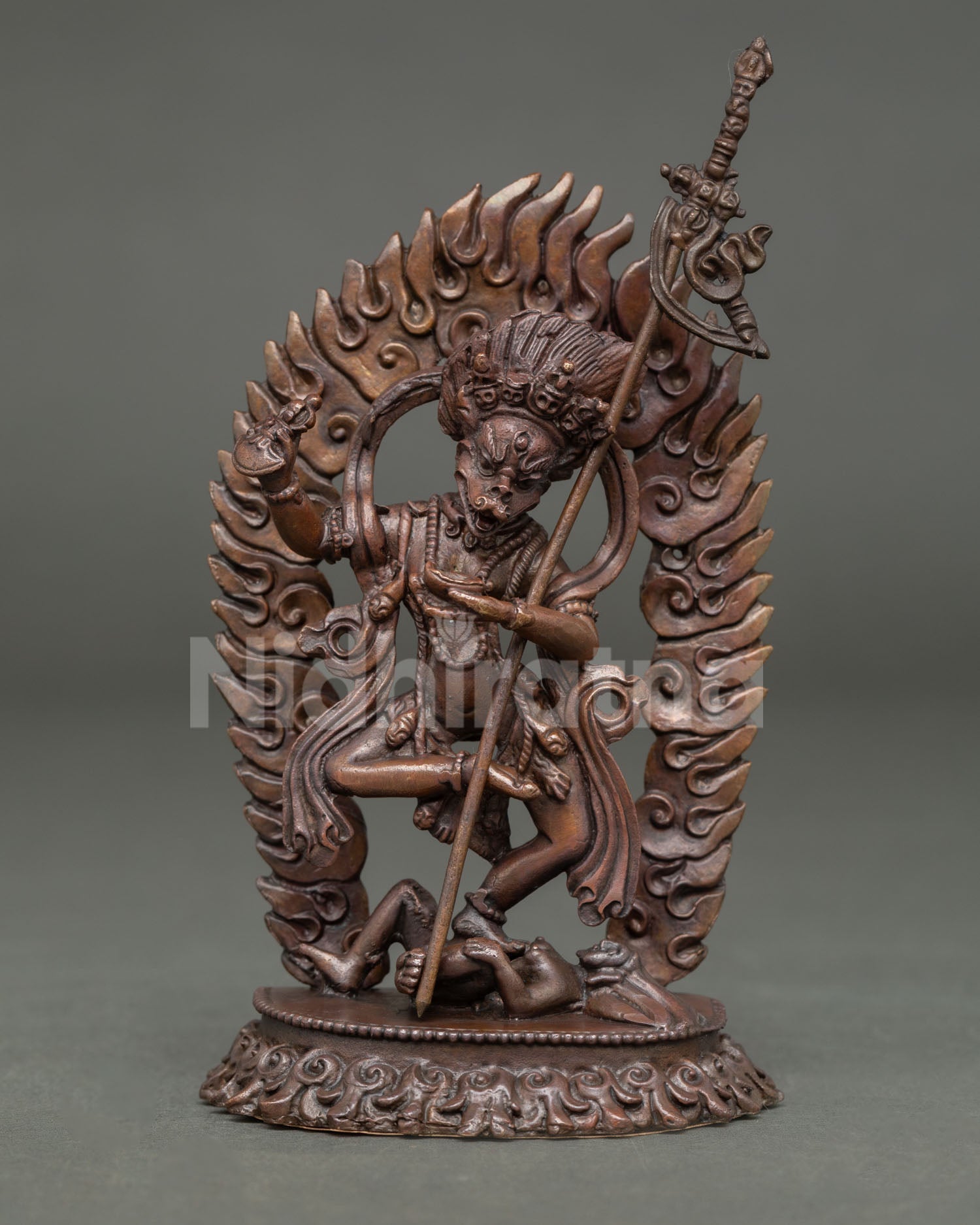 Front view of Simhamukha statue Lion-Faced Dakini handmade in copper with oxidized finish standing on subdued figure
